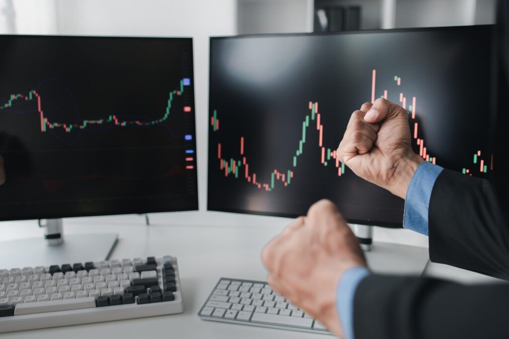 Two stock investors working together to analyze the stock market, business man is trading stocks for